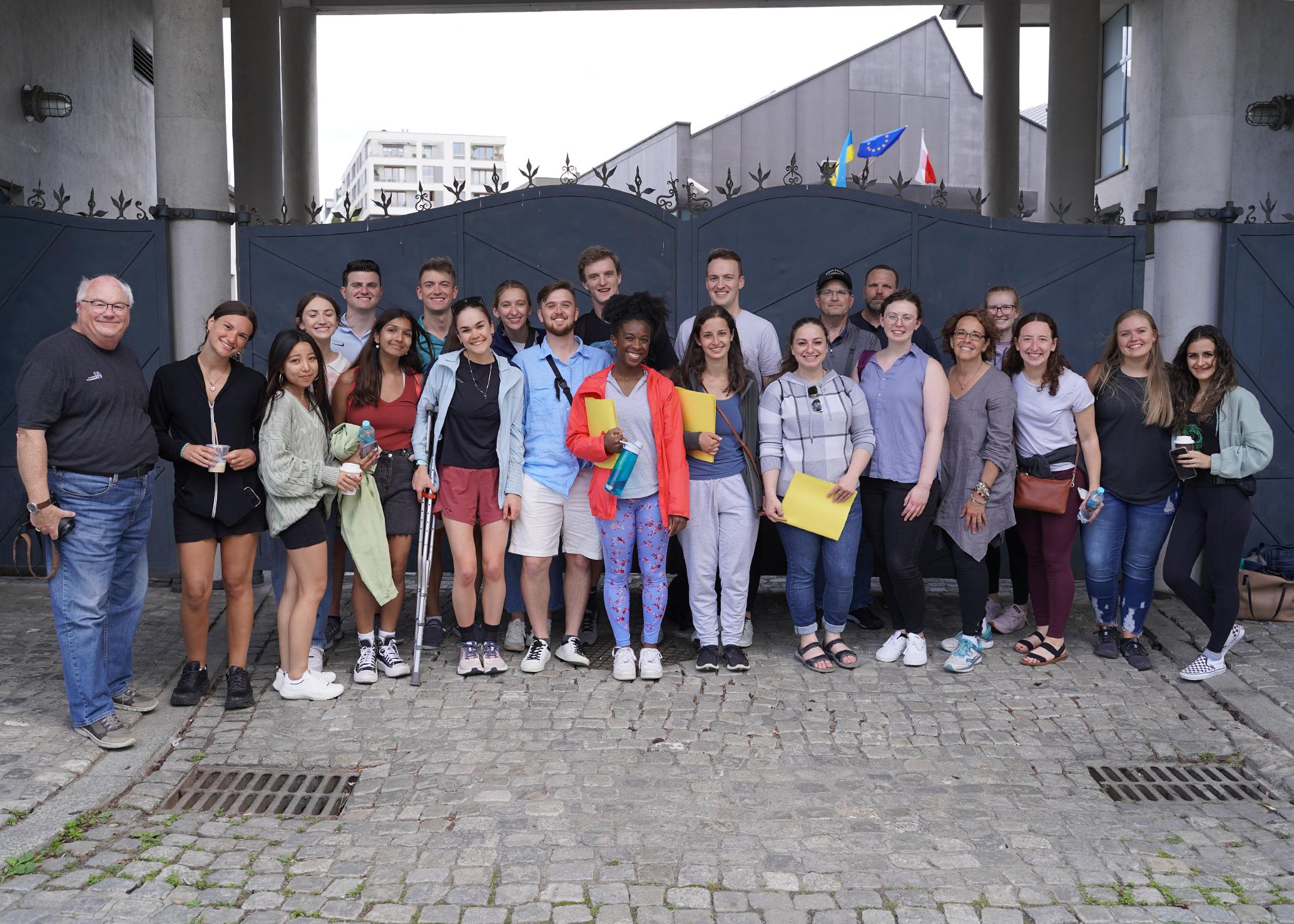 A group of students in front of the gates to Schindlers Factory, Krakow, Poland