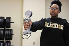 woman in a Golden Grizzlies sweatshirt holding a diabetes research tool